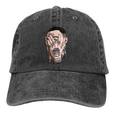 a black hat with a drawing of a man's face on the front and side