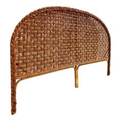 the headboard is made out of wicker and has an intricate design on it