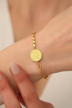 14K Solid Gold Ottoman Sign Coin Bracelet / Turkish Embossed  Coin  Bracelet / Ottoman Sign Pressed Disc Bracelet / Gold Coin Bracelet  * Gold KT: 14K Solid Gold * Gold Color: Dark Yellow Gold (The colors are exactly the same as in the photo) * Chain Lengths: 6"-8" Follow on Instagram - @bayargold.tr My Web Site - https://www.bayargold.com * Bayar Gold is a fine jewelry company. Please do not hesitate to ask us questions. We are always here to help you. * All items are packed in the high-quality jewelry box. The gift message is available. Please let us know what to write by leaving us a note at checkout.  * Gift wrapping available.  Express shipping * United States: 4-6 business days * Canada: 4-6 business days * Europe: 4-6 business days * Australia: 4-6 business days * UK: 4-6 business d Round Engraved Bracelets For Jewelry Making, Turkish Gold Jewelry, Gold Coin Bracelet, Man Gold Bracelet Design, Gold Ottoman, Gold Coin Jewelry, Photo Chain, Disc Bracelet, Coin Bracelet