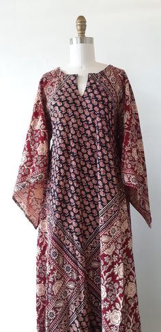 This vintage 1970s bohemian Indian cotton block print kaftan maxi dress is amazing! It features a gorgeous floral and graphic hand painted black and brown print, long angel bishop sleeves, a notch v-neckline and a full skirt. Fabulous!  ✂------ M E A S U R E M E N T S -------  best fit: fits most sizes  Dress bust: 41 inches waist free  hips: free sleeves: 27 1/2 inches Length: 59 inches tag/label - Union - RN59607 (FREE SIZE) - Wash in cold water with soap flakes, no detergent. Made in Pakistan material: cotton condition: Near mint, note this dress is not a gauze fabric / material. ★ Free Shipping - Processing, packaging and tracking are included. ★ Express shipping is available for U.S. & International orders for an additional cost! ★ Visit our shop at: https://www.etsy.com/shop/VivianVi 70s Bohemian, Block Print Dress, Brown Floral Print, Kaftan Maxi Dress, Cotton Kaftan, Brown Hats, 70s Dress, Gauze Fabric, Indian Cotton