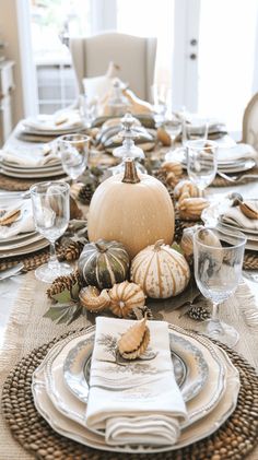 a dining room table set for thanksgiving dinner