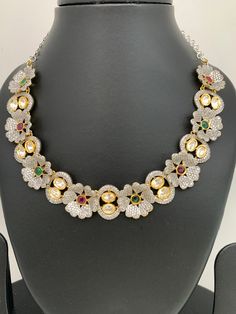 Floral Pattern Multi Stone Kundan Dual Tone Finish Neckline Necklace with Matching EarringsColor : GoldenSize : Necklace Length : Approx 16 Inches; Earring Length : 2.25 InchesStones : Kundan, Multi Stone Multicolor Hand Set Bridal Necklace, Hand Set Multicolor Bridal Necklace, Festive Multicolor Jeweled Bridal Necklace, Multicolor Choker Jewelry Sets For Celebration, Elegant Multicolor Bridal Choker Necklace, Elegant Multicolor Kundan Necklace With Stones, Elegant Multicolor Stone Jewelry Sets, Elegant Multicolor Choker Jewelry Sets, Necklace For Neckline