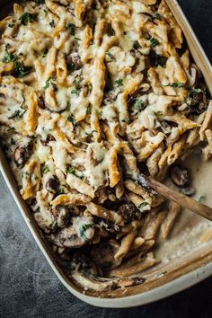 a casserole dish filled with pasta and mushrooms