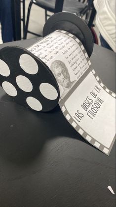 a roll of paper sitting on top of a table with a movie ticket attached to it