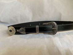 100% Genuine Leather Australian Made  This is Black leather western belt with small and big oval conchos with a Western three piece silver buckle set  , the belt is 38mm (1 1/2") and tapers down to 30mm where it buckles up , made to your requested waist size, waist size is from the buckle end of the leather to the middle hole then you will have three holes bigger and three holes smaller, just add your waist size in message to seller or message me , happy to help in custom work Classic Concho Belt Buckles For Rodeo, Classic Antique Belt Buckles For Ranch, Black Belt With Antique Buckle For Rodeo, Silver Leather Concho Belt Buckles, Western Style Black Belt For Ranch, Western Concho Belt Buckles For Western-themed Events, Western Silver Belt With Antique Buckle, Western Black Belt Buckles For Rodeo, Black Concho Belt Buckles For Ranch