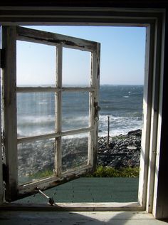 an open window looking out at the ocean