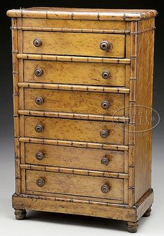 an old wooden dresser with many drawers and knobs on the front, in bamboo