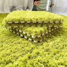 a close up of a cake on a table with a doll in the back ground