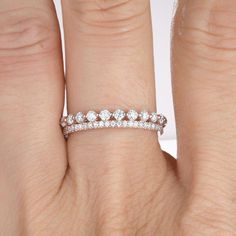 a woman's hand with a diamond ring on it