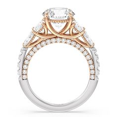 a white and gold engagement ring with an oval center stone surrounded by smaller round diamonds