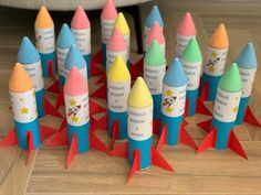 a bunch of colorful rockets sitting on top of a wooden floor