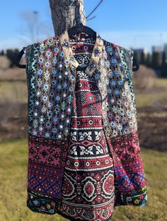 This Patchwork jacket is made of Hand embroidered panels stitched together to form a boho style vest. These embroidered patches were sourced from Tharparkar region of Sindh and some parts of Balochistan. Each section of embroidery consists of different styles of threadwork and mirror work native to the region, with some overlapping techniques of Baloch styles. Some of the styles of embroidery included are but not limited to: kaacha taanka, mirror work, Balochi tanka. The fabric itself has been e Bohemian Patchwork Vest For Festivals, Folk Style Multicolor Festival Vest, Bohemian Multicolor Patchwork Vest, Bohemian Multicolor Embroidered Vest For Festivals, Festival Embroidered Multicolor Vest, Festival Multicolor Embroidered Vest, Bohemian Floral Embroidered Outerwear For Festivals, Bohemian Festival Vest With Floral Embroidery, Folk Style Multicolor Outerwear For Festivals