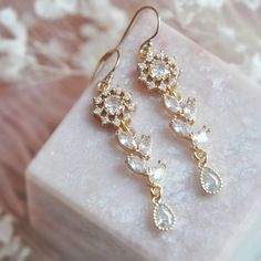 "Daisy Earrings // Bohemian Earrings // Flower Earrings // Wedding Jewelry // Leaf Earrings // Boho bridal Jewelry // 14k Gold Filled Earrings These daisy flower earrings feature a radiant floral design accented with tiny leaves and teardrops for added sparkle. The bohemian earrings are created with dainty 14k gold filled earrings wires for a comfortable all day wear. Whether searching for boho bridal jewelry for your wedding day, or a sweet gift for mom all of my jewelry arrives suitably gift w Delicate Single Diamond Earring For Wedding, Elegant Flower Drop Earrings For Celebrations, Dainty Dangle Diamond Earrings For Wedding, Single Teardrop Diamond Earring For Wedding, Teardrop Diamond Single Earring For Wedding, Wedding Teardrop Diamond Single Earring, Delicate Teardrop Earrings For Party, Dainty Drop Bridal Earrings For Party, Dainty Teardrop Diamond Earrings For Weddings