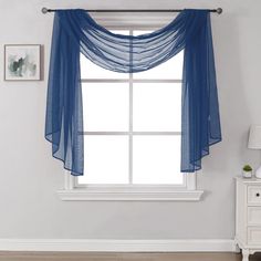 a blue sheer curtain hanging over a window