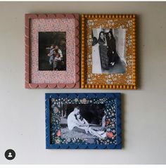 three different colored frames hanging on the wall