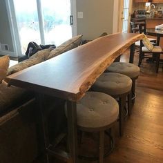 a wooden table sitting in the middle of a living room