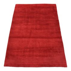 a red rug on a white background with no one in the photo to describe it