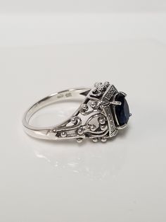 "Thanks for shopping our vintage estate store. We tend to sell well below wholesale and truly hope you enjoy all of our items. Many of the items are one of a kind, so please enjoy scrolling through the pictures and hopefully something will catch your eye. Black spots are from camera. Nice estate sterling silver 925 created blue 1ct Sapphire filigree ring. This is a custom made ring, meaning we added the gem to the setting. Ring size: please select a size Setting: 5/8\" 10mm Band width: 2mm Weigh Classic Oval Sterling Silver Filigree Ring, Classic Oval Filigree Ring Stamped 925, Sterling Silver Sapphire Ring With Filigree For Anniversary, Vintage Silver Sapphire Ring In Sterling Silver, Vintage Sapphire Jewelry With Intricate Design, Vintage Sapphire Ring With Accent Stones, Classic Sapphire Filigree Ring With Gemstone, Classic Filigree Ring For Formal Occasions, Elegant Oval Sapphire Ring Stamped 925