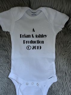 a white onesuit with the words'a britain and ashley production'printed on it