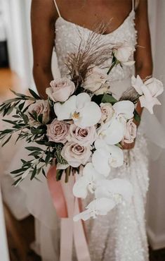 a bride holding a bouquet of flowers in her hand