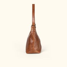 Walker Leather Shoulder Bag | Rustic Tan hover Classic Hobo Bag With Leather Handles For On-the-go, Cognac Bag With Brass Hardware For Everyday Use, Timeless Leather Hobo Bag, Cognac Satchel With Brass Hardware For Everyday, Everyday Cognac Satchel With Brass Hardware, Leather Flap Bag For On-the-go, Timeless Top Handle Hobo Bag With Leather Lining, Leather Satchel With Brass Hardware And Double Handle, Timeless Hobo Bag With Leather Lining And Top Handle