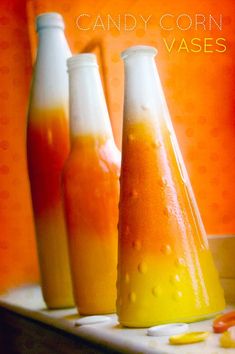 three bottles filled with liquid sitting on top of a table