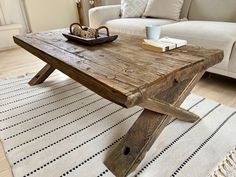 a wooden table sitting on top of a white rug