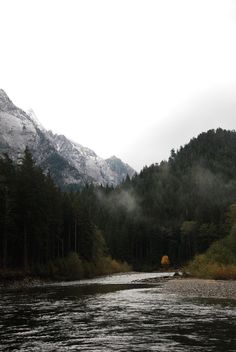 a river with mountains in the background