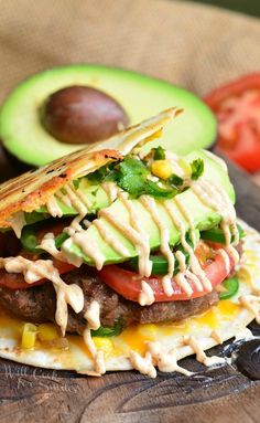 an avocado and tomato sandwich on a tortilla