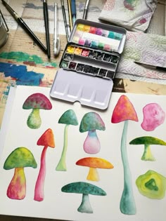 watercolors are being used to paint colorful mushrooms