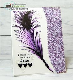 a card with some purple feathers on it