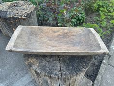 a wooden bowl sitting on top of a tree stump