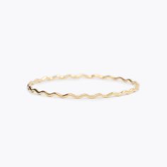 This wavy design was inspired by the gold edges of Susan Gordon’s signature handmade pottery. A collaboration piece between SGP and Yearly Co. perfect for representing the ups and downs in life. A 1.8mm round, solid 14k gold bangle.If you want to customize a Wavy Bangle with diamonds, email us at hello@yearlyco.com. Minimalist Wavy Yellow Gold Jewelry, Minimalist 14k Gold Wavy Jewelry, Gold Wavy Jewelry For Everyday, Everyday Yellow Gold Wavy Jewelry, Everyday Wavy Yellow Gold Jewelry, Ups And Downs In Life, Bangle With Diamonds, Surprises For Husband, Wavy Design