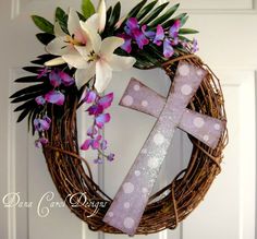 a wreath with a cross and flowers on it