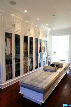 a bed sitting on top of a hard wood floor next to a walk in closet