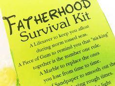 a fatherhood survival kit sitting on top of a table next to a lemon slice