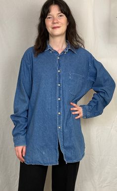 Add a timeless piece to your wardrobe with this Vintage 90s Blue Denim Unisex Shirt. Perfectly embodying the classic 90s style, this denim shirt is versatile, durable, and effortlessly cool. The authentic blue denim and relaxed fit capture the essence of the 90s, making it a staple for any vintage lover. Its versatile style and fit make it perfect for all genders and is very comfortable and the sturdy denim fabric ensures durability. Pair it with jeans for a double denim look, or style it with a Vintage Denim Blue Tops With Relaxed Fit, Classic Denim Shirt For Streetwear, Vintage Relaxed Fit Medium Wash Shirt, Classic Oversized Denim Tops, Vintage Denim Top For Everyday Wear, Vintage Washed Blue Denim Shirt, Vintage Dark Wash Denim Shirt, Oversized Medium Wash Cotton Shirt, Vintage Medium Wash Denim Shirt