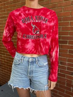 -Upcycled Ball State University Acid Washed Cropped Long Sleeve Shirt -Hem has a raw edge -Second-hand materials may have small imperfections that enhance its individual character -Women's size small. Model in photos is 5'10" & 130 lbs, typically wears a size S or M in tops -Ready to ship in 1 business day! Ball State University Apparel, Long Sleeve Summer Shirt For College, Red Tops With School Spirit For Fall, Red School Spirit Tops For Fall, Relaxed Fit Shirt For College Spring Season, Relaxed Fit Shirt For College In Spring, Red Tops For Fall School Spirit, College Spirit Tops For Spring, Trendy Tie Dye Long Sleeve Top