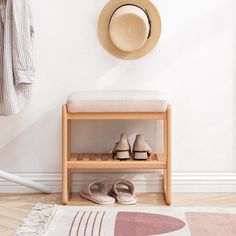 a pair of shoes sitting on top of a wooden bench next to a hat and coat rack