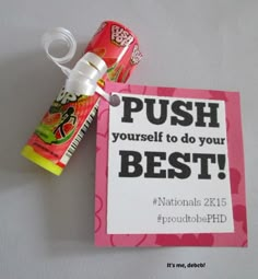 a sign that says push yourself to do your best with candy sticks in front of it