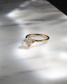 a diamond ring sitting on top of a table