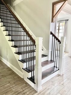 the stairs in this house are made of wood and wrought iron