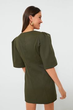 Perfect for drinks, dinners, and brunches alike, the Olive Twill Ariella Dress features an eye-catching silhouette in the color of the season. This fitted mini features half-length bell sleeves with double pleats at the shoulder for shape, and a U-scoop neckline that is perfect for displaying fun necklaces. Pair with heels, ballet flats, or sandals- this beauty goes with anything and everything! U-scoop neckline Half-length bell sleeves with puff shoulders Invisible side zip closure Princess sea Fun Necklaces, Plus And Minus, Cocktail Attire, Whale Tail, Princess Seams, Cool Necklaces, Low Iron, Office Fashion, Pullover Sweatshirts