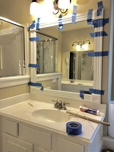 a bathroom sink with blue tape taped around it