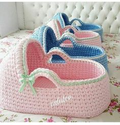 six pink and blue baskets sitting on top of a bed