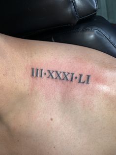 a man's arm with roman numerals tattooed on the upper half of it