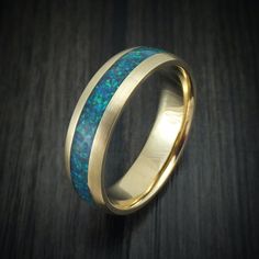 This 14K Gold (pictured with Yellow Gold) ring features:- A Satin Finish- A 3mm Crushed Opal Inlay (Pictured with Pacific Sapphire Opal)- A Domed Design- 6mm Width Sapphire Wedding Band, Opal Ring Gold, Wave Ring, Pattern Ring, Synthetic Opal, Opal Color, Initial Ring, Mens Band, Yellow Gold Ring