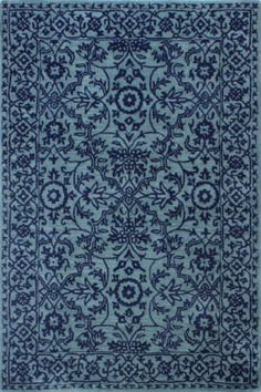 a blue and white rug with an intricate design