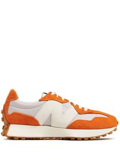 carrot orange suede colour-block panelled design logo print to the side appliqué logo logo patch at the tongue round toe front lace-up fastening branded insole speckled sole Casual New Balance Sneakers With Logo Patch, Orange Suede Lace-up Sneakers, Orange Running Shoes With Rubber Waffle Outsoles For Jogging, New Balance Leather Sneakers With Logo Patch, Orange Low-top Sneakers With Contrast Sole, Orange Sneakers With Rubber Waffle Outsoles, Orange Low-top Running Shoes With Rubber Sole, Casual Orange New Balance Sneakers, Sporty Orange New Balance Running Shoes