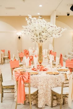 the tables are decorated with white flowers and orange sashes